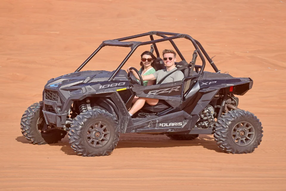 Couple enjoying a 30-min Polaris dune buggy thrill ride in Dubai
