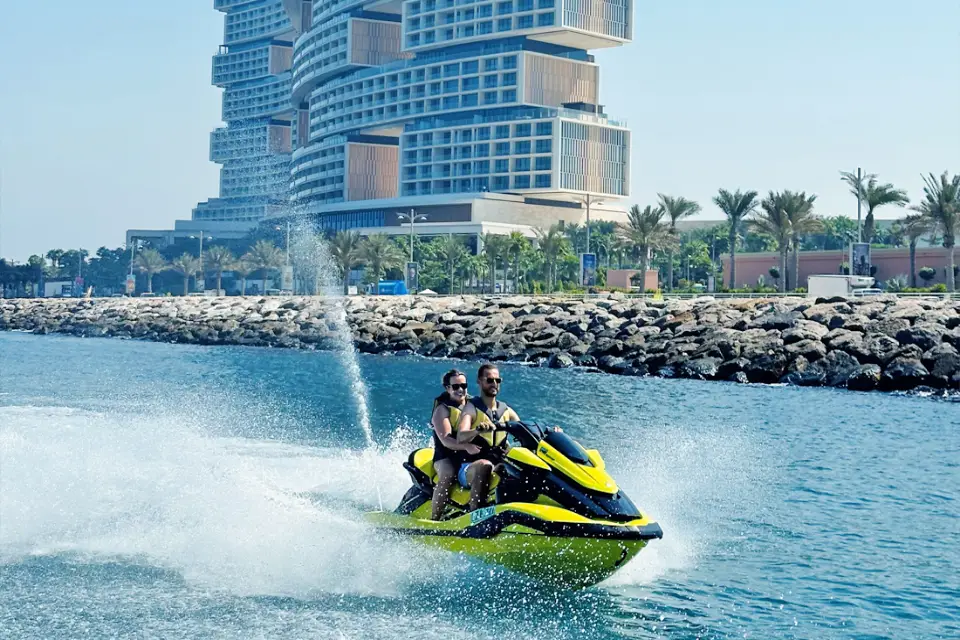 Guided jetski tour with guest drifting on water next to royal atlantis.
