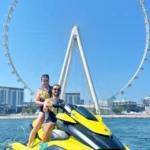 Guest Posing next to Ain Wheel dubain on a jetski near Palm Jumeirah Area