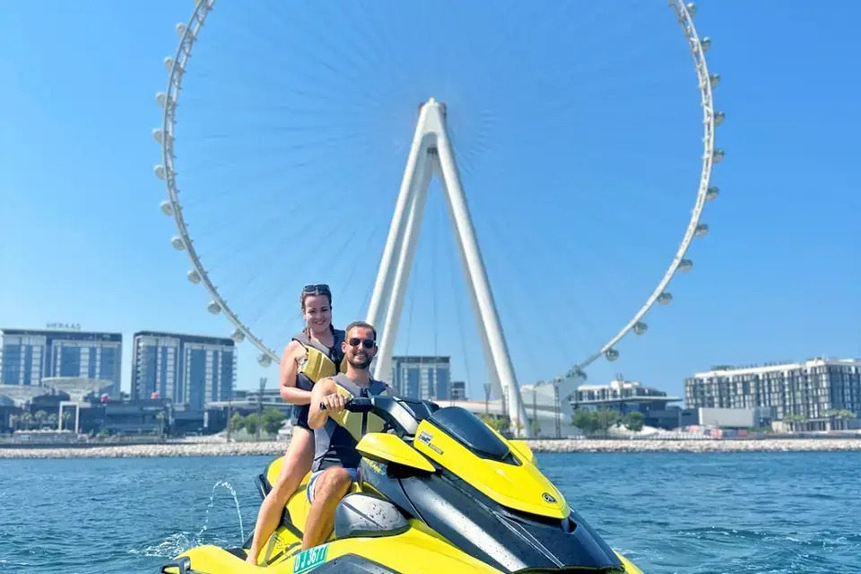 Guest Posing next to Ain Wheel dubain on a jetski near Palm Jumeirah Area