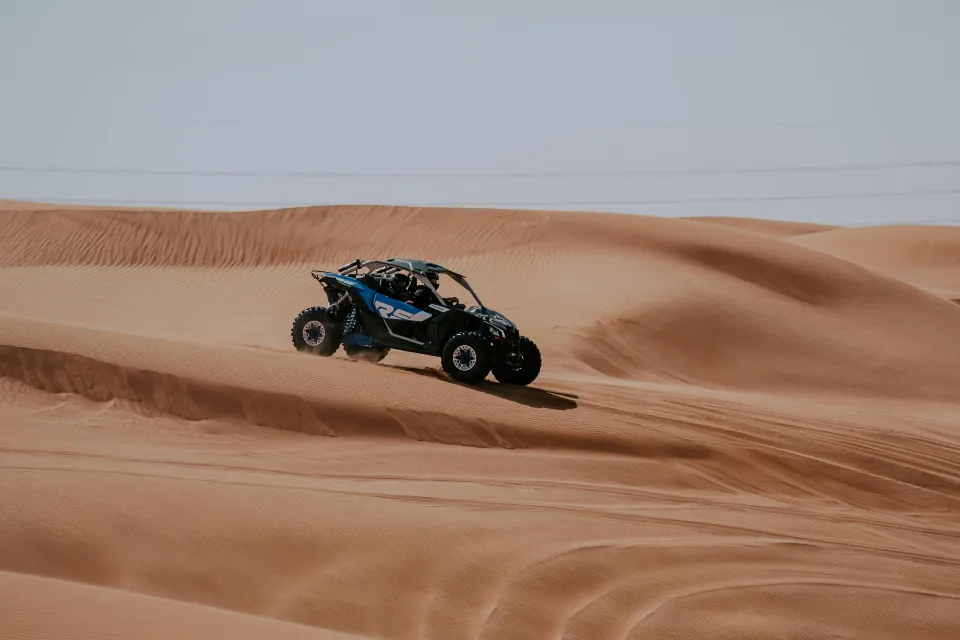 dubai desert dune buggy in lahbab desert sliding down a dune